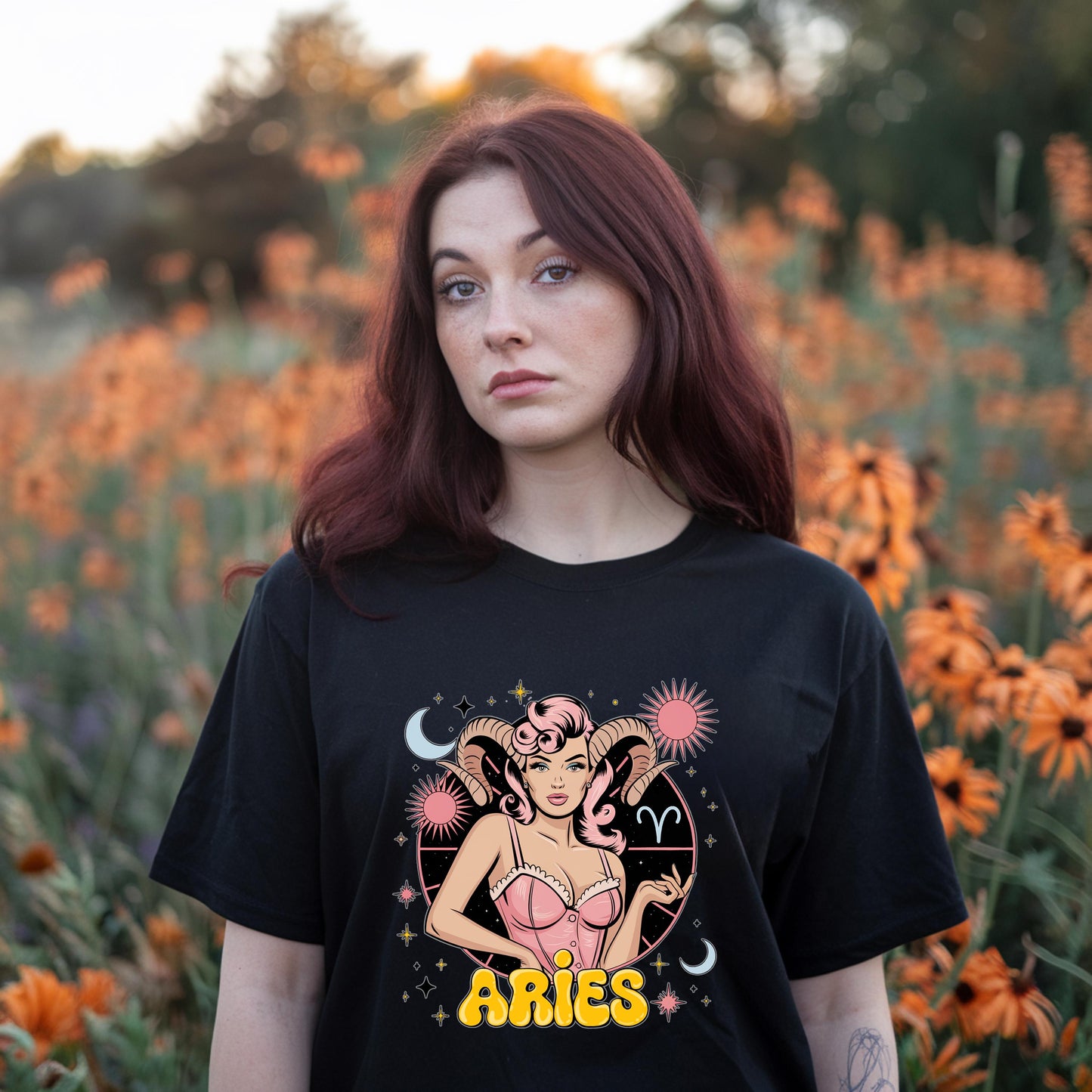 Vintage style black tee featuring Aries goddess graphic with ram horns, sign & celestial details. Astrology apparel.