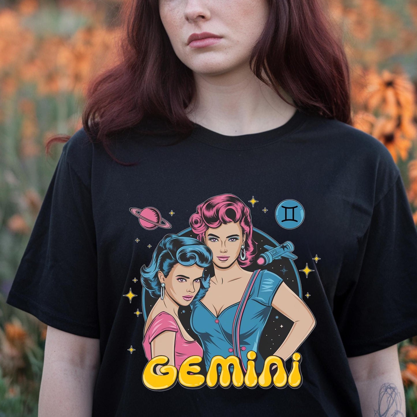 Girl in field of flowers wearing a Black Vintage Gemini zodiac t-shirt.